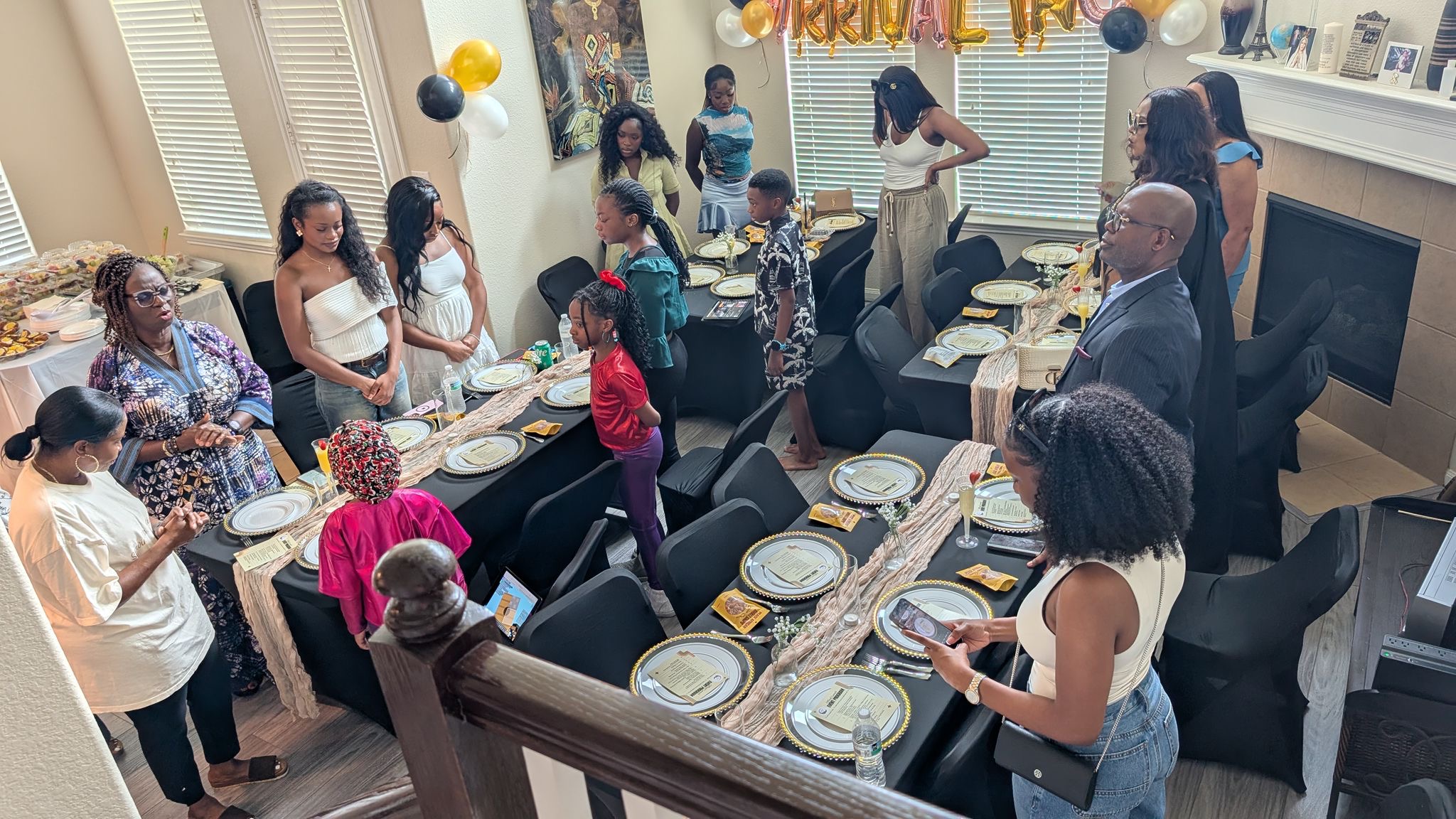 A wide overhead view of guests seated around tables during the grand opening.