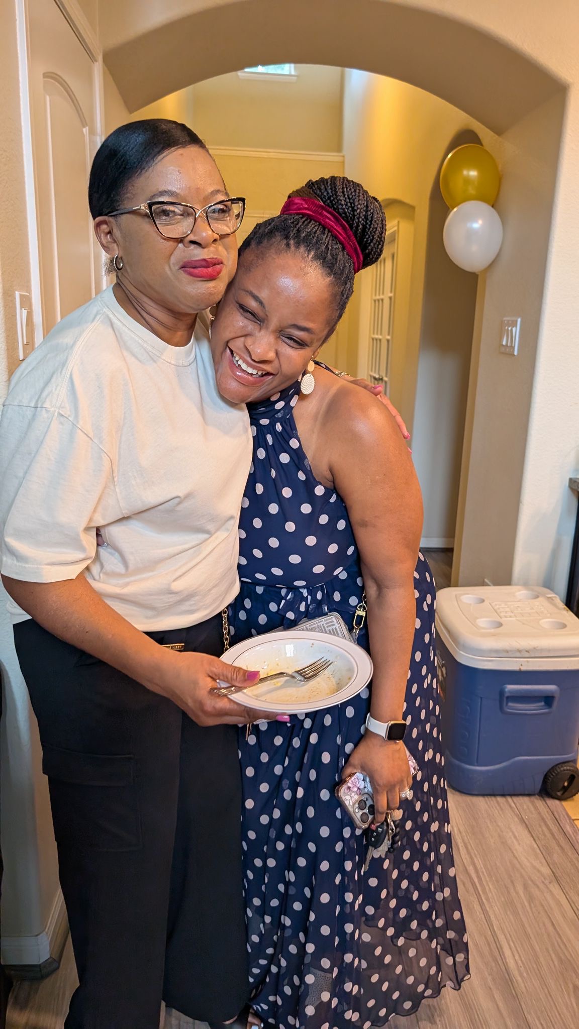 A warm candid embrace during the Help On Arrival grand opening.