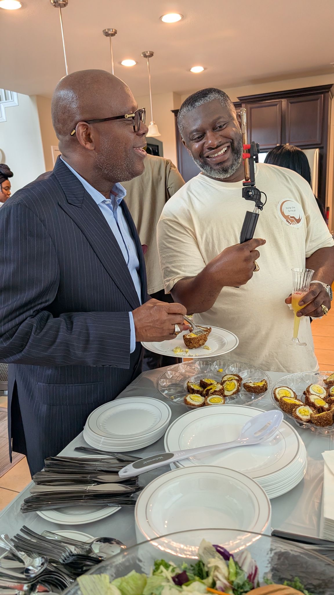 A candid conversation during the Help On Arrival grand opening.