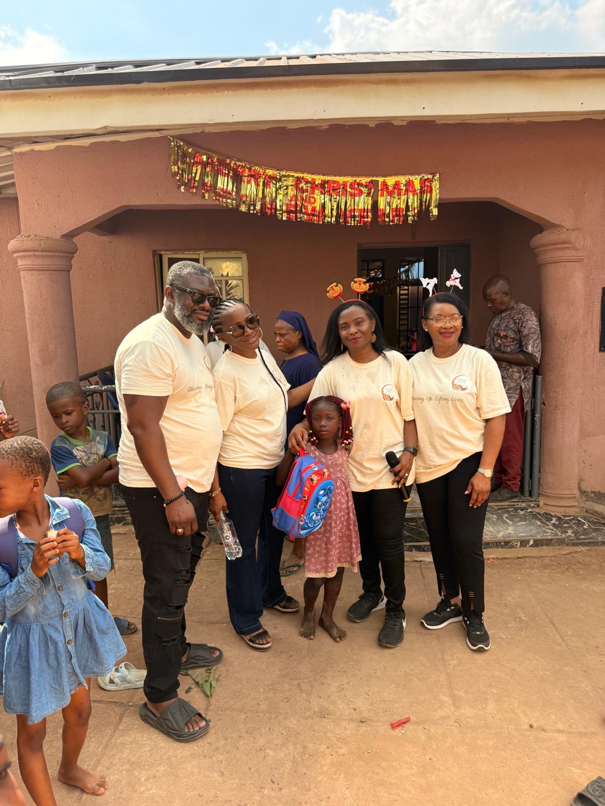Help On Arrival team members posing with a young child and backpack.