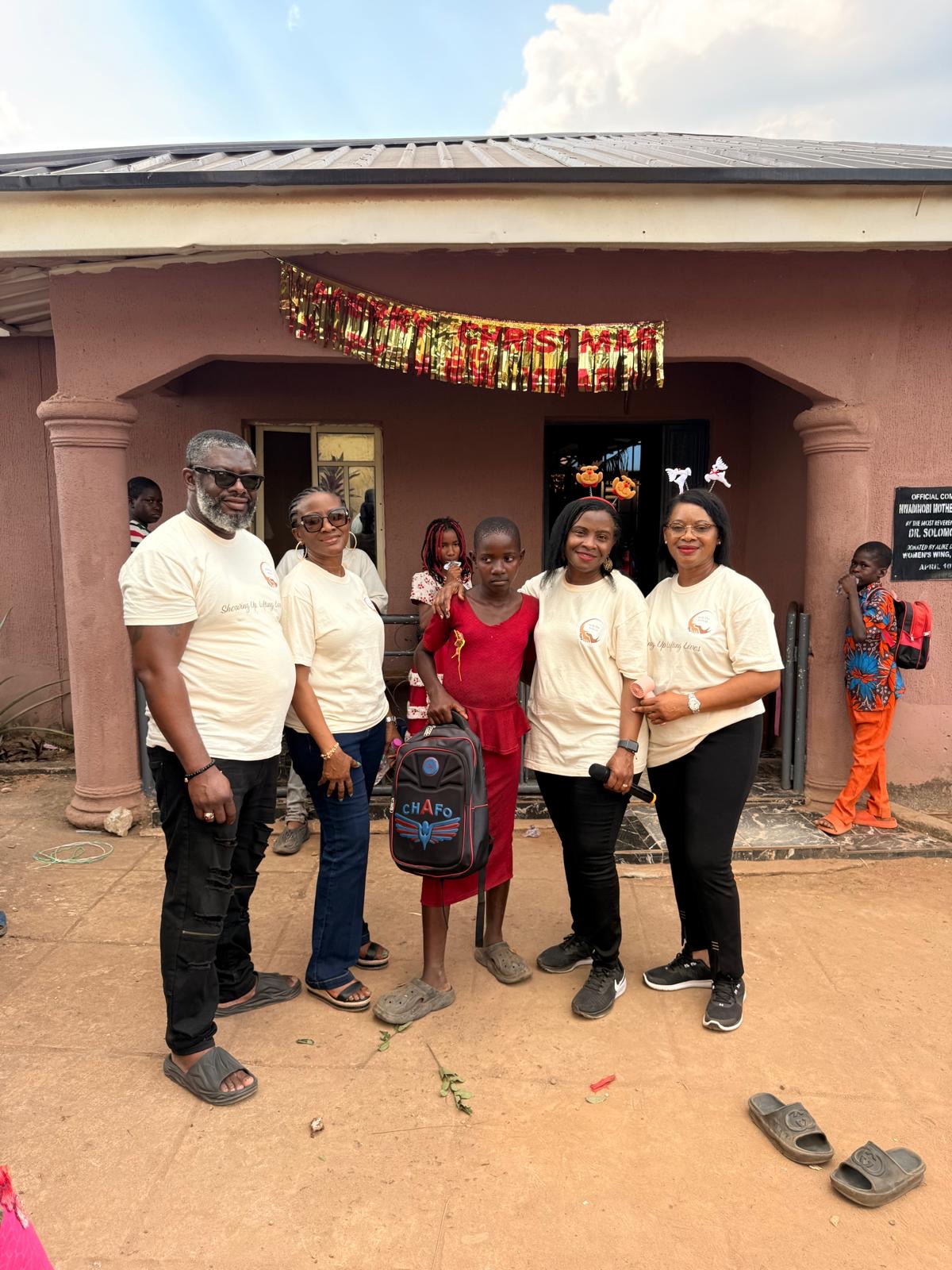 Help On Arrival team members standing with a child carrying a backpack.