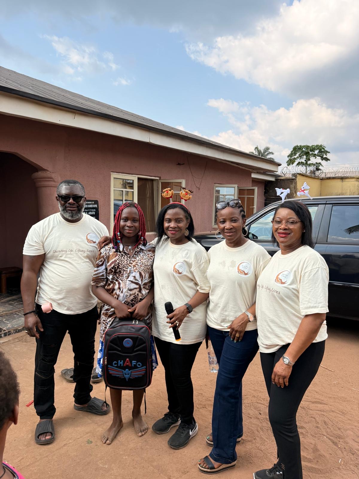 Help On Arrival team members and a child standing together outside.