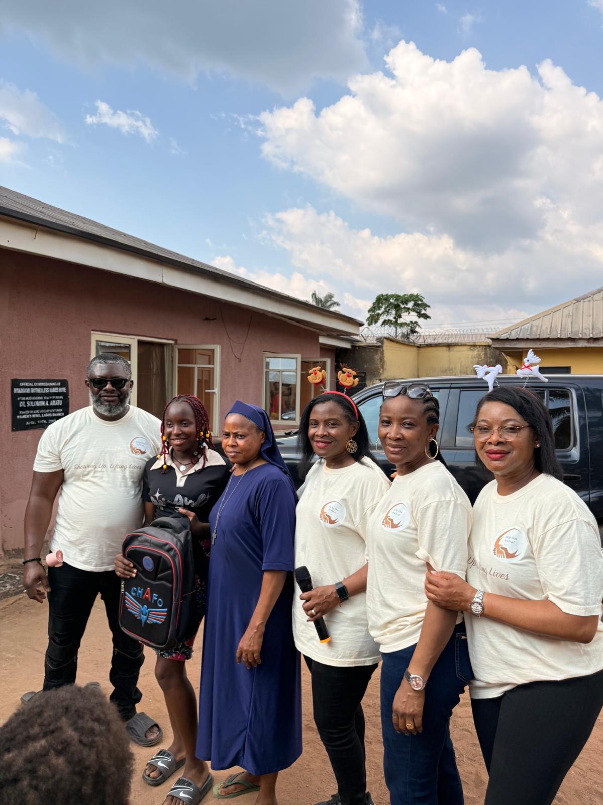 Help On Arrival team members and a caretaker standing outside the orphanage.