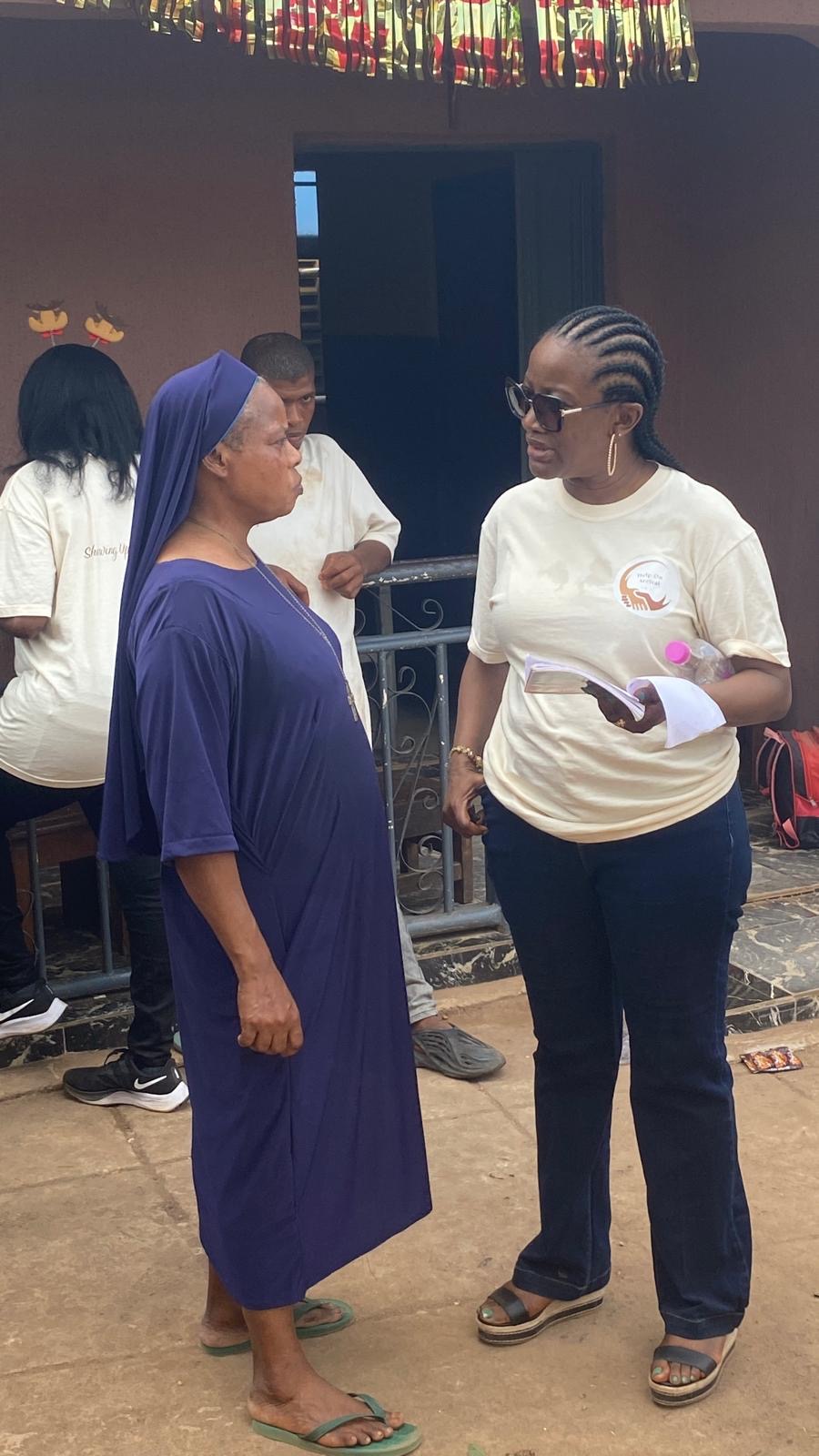 A Help On Arrival team member speaking with a nun outside the orphanage